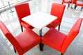 Four red chairs at a table