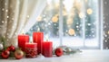 Four red Christmas candles on a table by winter view window Royalty Free Stock Photo