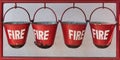 Four red fire buckets, closeup Royalty Free Stock Photo