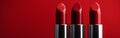 Four Red Lipsticks on Red Background Royalty Free Stock Photo