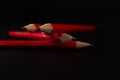 Four red pens placed one followed by another in perspective Royalty Free Stock Photo