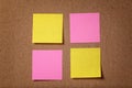 Four reminder sticky notes on cork board Royalty Free Stock Photo