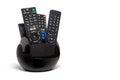 Four remote controls stacked in holder. Royalty Free Stock Photo