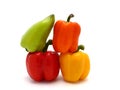 Four ripe sweet peppers on a light background. Red, yellow, green and orange. Royalty Free Stock Photo