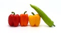 Four ripe sweet peppers on a light background. Red, yellow, green and orange. Royalty Free Stock Photo