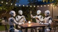Four robots are drinking and celebrating at night. Royalty Free Stock Photo