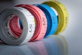 Four rolls of colorful measuring tapes