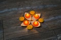 Four round orange candle burning in the stands of the orange pee Royalty Free Stock Photo
