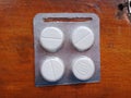 Four round tablets of medicine