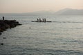 Four rowers rowing a boat standing