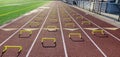 Four rows of mini hurdles set up on a track in lanes