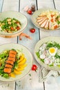 Four salads on a white wooden background