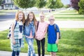 Four school kids heading off to school in the morning Royalty Free Stock Photo