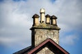 Four Scottish stone chimneys stacks against a blue sky