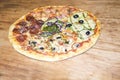 Four Seasons Pizza on a wooden background