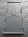 Four section door with hooks in grey wall