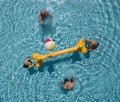 Four senior people in the swimming pool with inflatable net and ball. Two elderly brothers and their wifes having fun. Bright Royalty Free Stock Photo