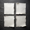 Four sheets of white torn paper on a black wall Royalty Free Stock Photo