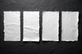 Four sheets of white torn paper on a black wall Royalty Free Stock Photo