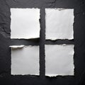 Four sheets of white torn paper on a black wall Royalty Free Stock Photo