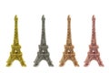 Four shiny figurines of the Eiffel tower in different colors.isolate