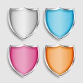 Four shiny metallic shield symbols or icons set