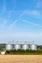 four silos in rural area at the field in spring time Royalty Free Stock Photo