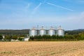 four silos in rural area at the field in spring time Royalty Free Stock Photo