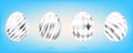 Four silver eggs on the sky blue background. Isolated objects for Easter. Stripes and diamonds ornate Royalty Free Stock Photo