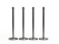 Four silver stanchion posts arranged in a row on white background event queue barrier Royalty Free Stock Photo
