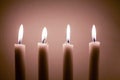 Four simple lighted candles