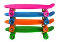 Four skateboards of different colors, with a plastic deck, are stacked one on top of the other, on a white background Royalty Free Stock Photo