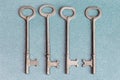 Four Skeleton Keys on a blue background Royalty Free Stock Photo