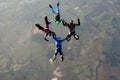 Four skydivers doing formations