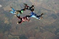 Four skydivers doing formations