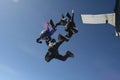 Four skydivers exit a plane