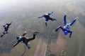Four skydivers in the sky.
