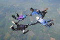 Four skydivers holding hands