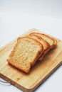 Four slices of bread on the wooden cutting board in white background. Royalty Free Stock Photo