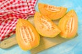 Four slices of cantaloupe melon on rustic table Royalty Free Stock Photo
