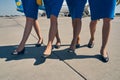Four slim Caucasian stewardesses wearing court shoes