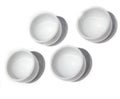 Four small l bowls on a white background