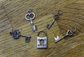 Four small decorative skeleton keys around a closed old fashioned lock Royalty Free Stock Photo