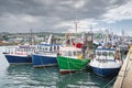 Four small fishing boats moored in Howth harbour, Dublin, Ireland Royalty Free Stock Photo