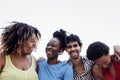 Four smiling mixed race friends standing and looking down at camera Royalty Free Stock Photo