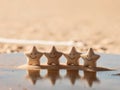 Four Smiling Star Figurines on a Beach Restaurant Table. Royalty Free Stock Photo