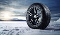 Four snow tires are shown in the snow