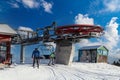 Four snowboarders descend to the ski chairlift