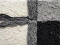 Four soft squares made of yarn are displayed, each one a different shade of gray Royalty Free Stock Photo
