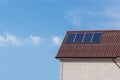 Four solar panels are installed on the roof slope of the house Royalty Free Stock Photo
